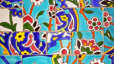 Colourful tiles showing green, red, blue and black flowers in vibrant hues