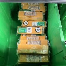 Blocks of orange chees in a green crate
