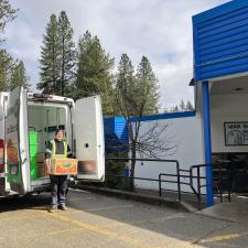 A delivery person unloads a box of food from a van
