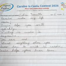 A lined paper with student cursive writing filling part of the page
